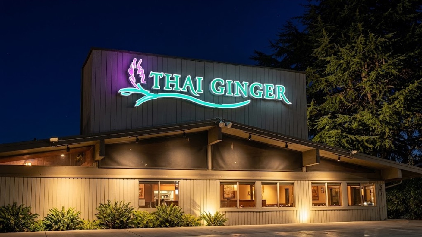 Thai Ginger Factoria — freestanding building at dusk, neon sign lit above the entrance.